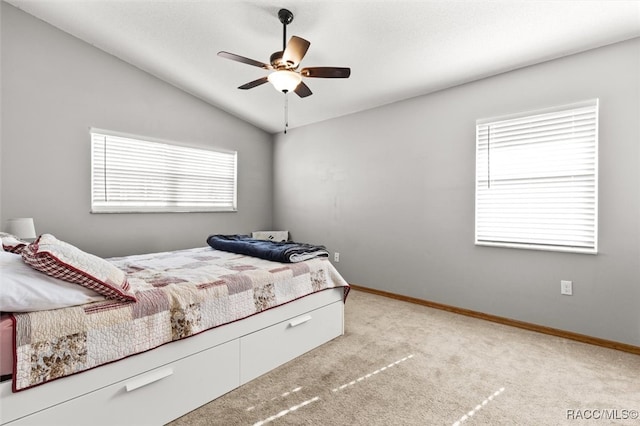 carpeted bedroom featuring ceiling fan and lofted ceiling