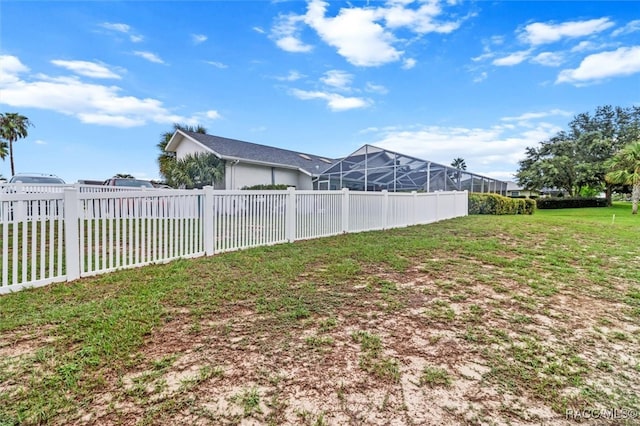 view of yard with glass enclosure