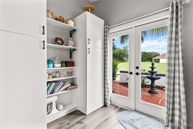 doorway with french doors and light hardwood / wood-style flooring