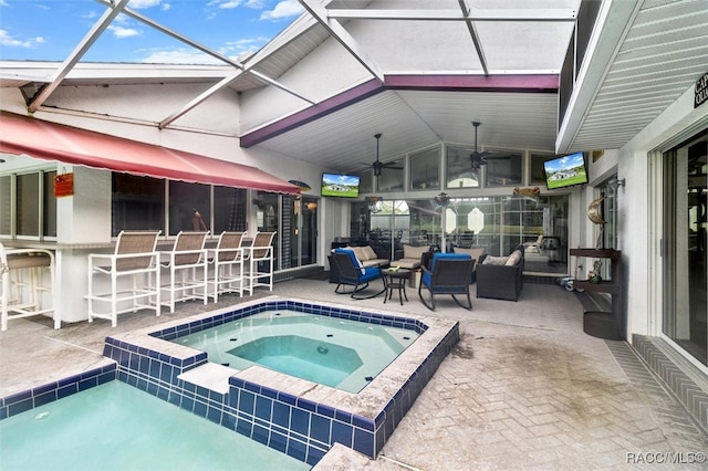 view of swimming pool with outdoor lounge area, a lanai, an in ground hot tub, a bar, and a patio