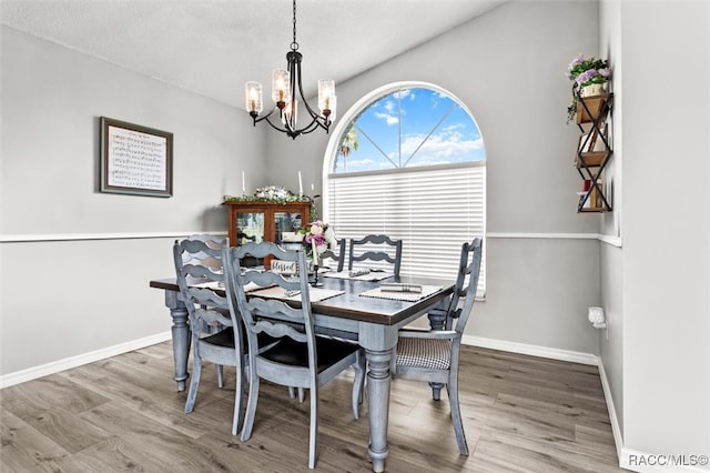 dining room featuring a chandelier, a textured ceiling, and wood-type flooring