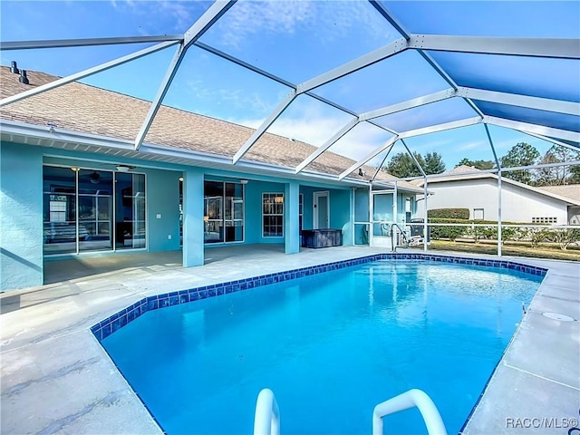 view of swimming pool with a lanai, a patio, and ceiling fan