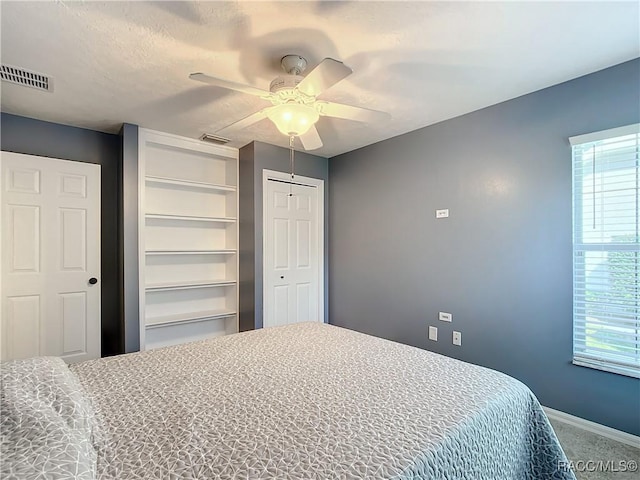 bedroom with ceiling fan and carpet floors