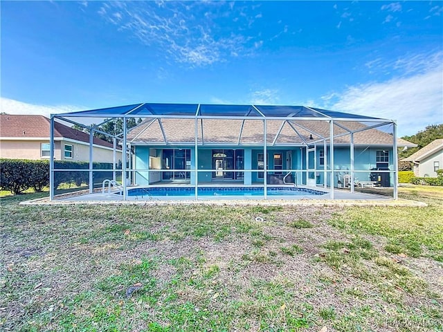 back of property featuring a yard, a lanai, and a patio area