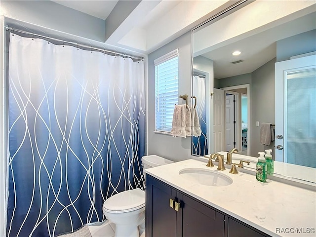 bathroom featuring toilet and vanity