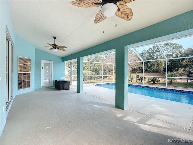 view of swimming pool with a lanai, a patio area, and ceiling fan