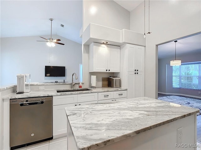 kitchen with white cabinets, hanging light fixtures, stainless steel dishwasher, and sink