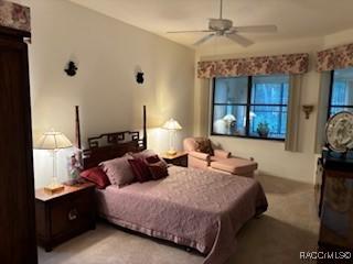 bedroom featuring light colored carpet and ceiling fan