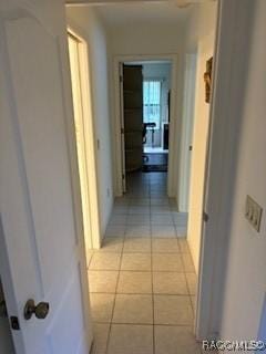 corridor featuring light tile patterned floors