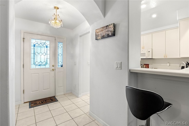 entryway with light tile patterned floors and sink