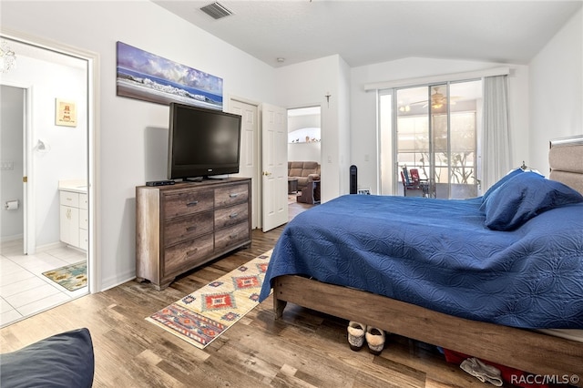 bedroom with access to outside, connected bathroom, light hardwood / wood-style flooring, and lofted ceiling