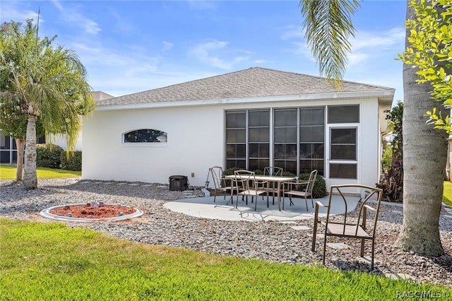 back of house featuring a lawn and a patio