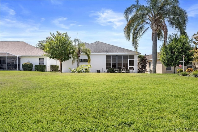 rear view of property with a yard