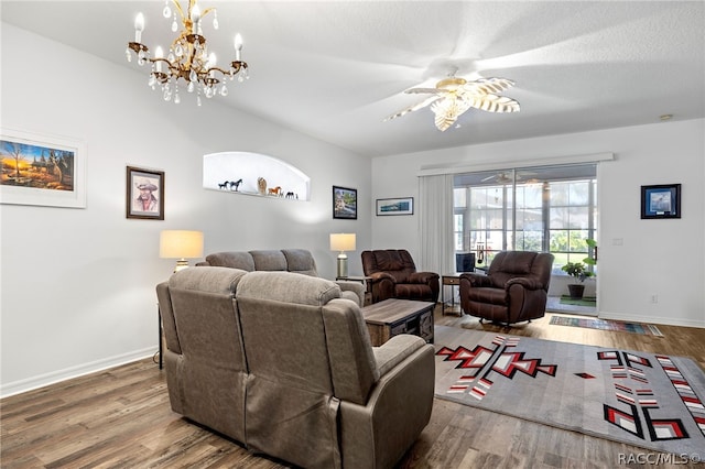 living room featuring hardwood / wood-style floors, ceiling fan with notable chandelier, and a textured ceiling