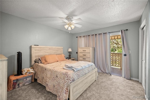 bedroom with ceiling fan, access to outside, carpet flooring, and a textured ceiling
