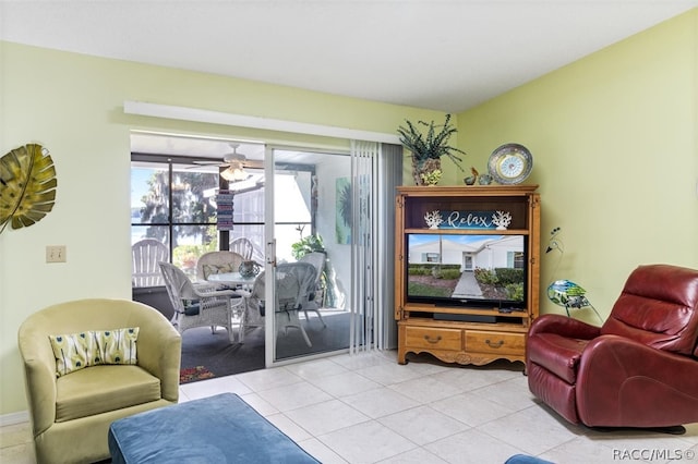 living area with light tile patterned floors and ceiling fan