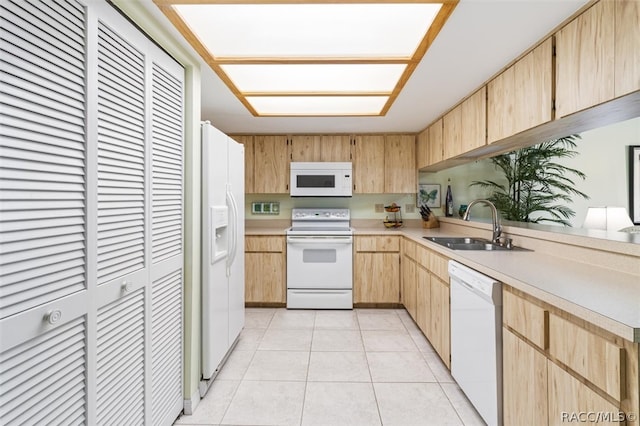 kitchen featuring light brown cabinets, light tile patterned flooring, white appliances, and sink