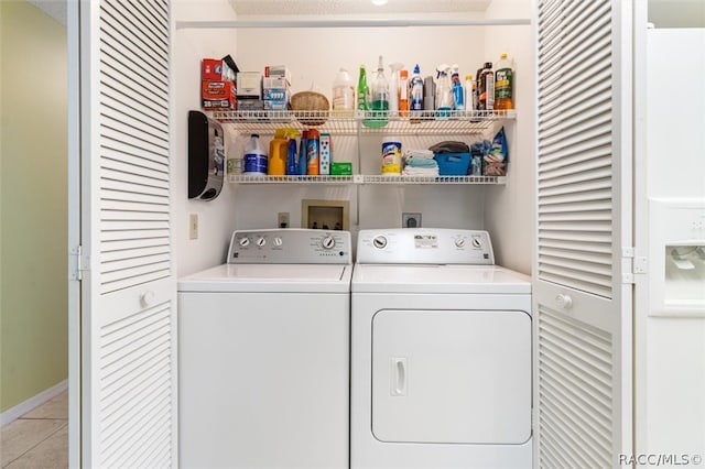 washroom featuring washing machine and clothes dryer and light tile patterned floors