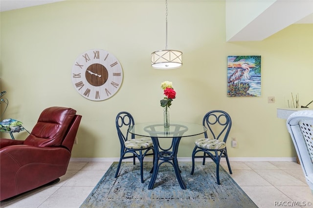 dining room featuring light tile patterned flooring and lofted ceiling