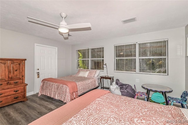 bedroom with dark wood-style floors, ceiling fan, and visible vents