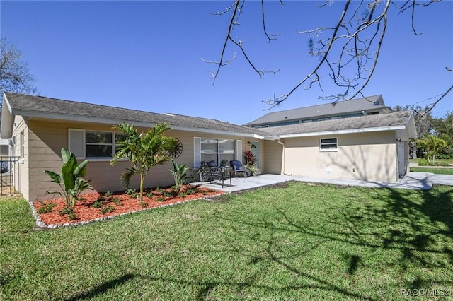 back of property featuring a patio area and a lawn