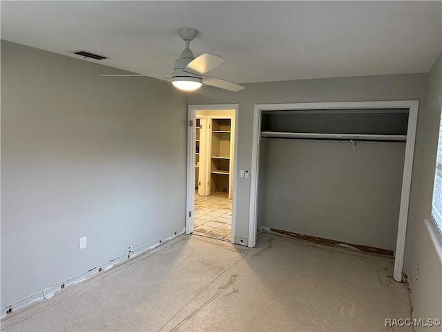 unfurnished bedroom featuring a ceiling fan, visible vents, and a closet