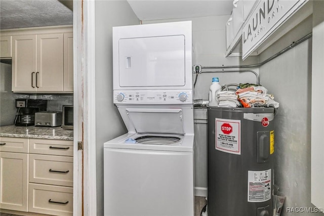 washroom with stacked washer / drying machine, laundry area, and electric water heater