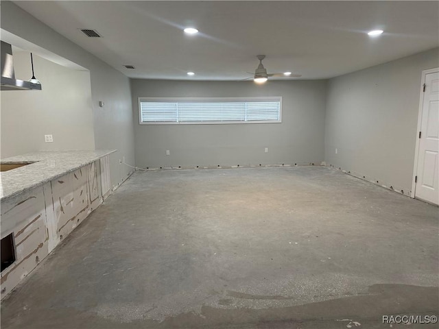 empty room with ceiling fan, unfinished concrete floors, visible vents, and recessed lighting