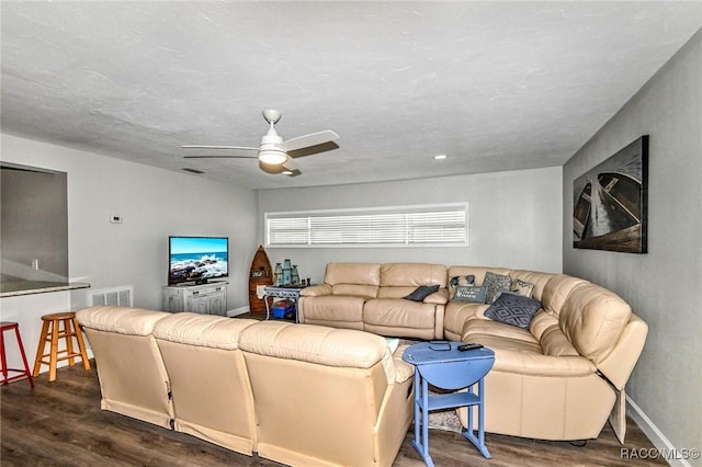 living area with baseboards, ceiling fan, visible vents, and wood finished floors