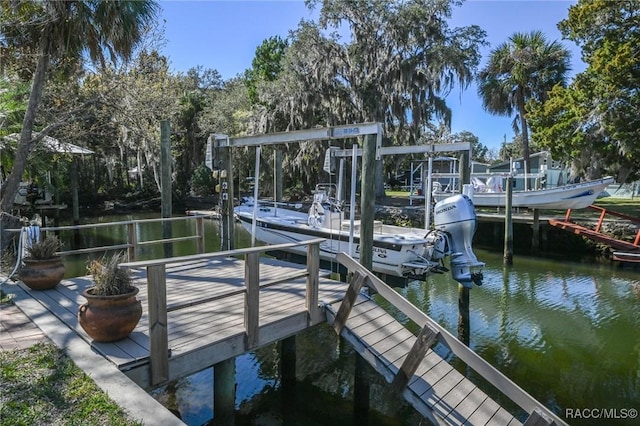 dock area featuring a water view and boat lift