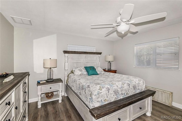 bedroom featuring baseboards, visible vents, and dark wood-type flooring