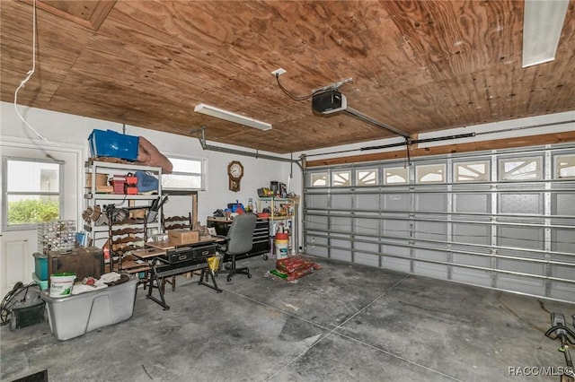 garage featuring a garage door opener and wood ceiling