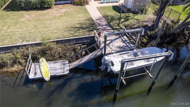 dock area featuring a yard, a water view, and boat lift