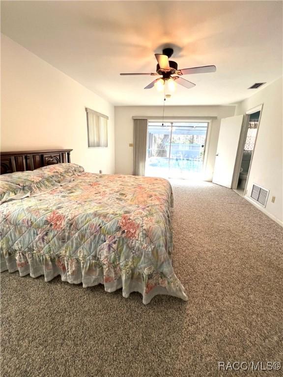 bedroom featuring ceiling fan and carpet