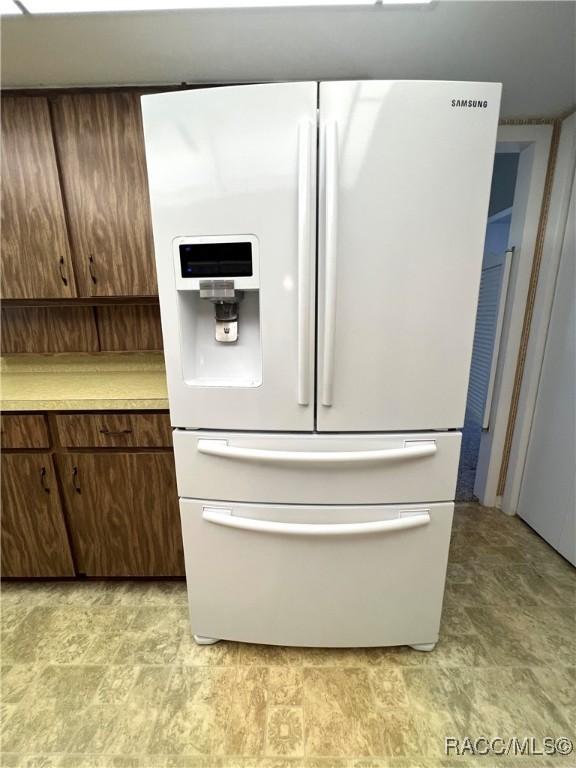 kitchen with white fridge with ice dispenser