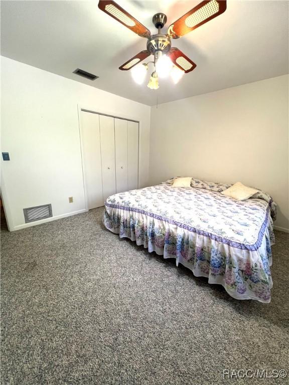 bedroom featuring ceiling fan and a closet