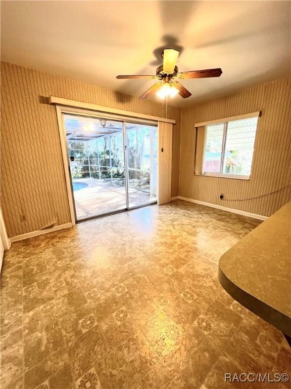 interior space with a wealth of natural light and ceiling fan