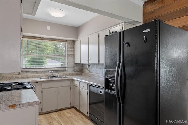 833 Maple Ave, Inverness, FL 34452 - kitchen featuring black appliances, a sink, white cabinets, light countertops, and light wood-style floors