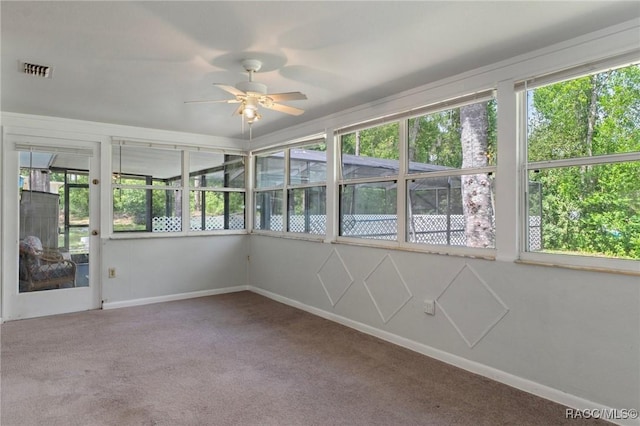 833 Maple Ave, Inverness, FL 34452 - unfurnished sunroom featuring plenty of natural light, carpet flooring, and baseboards