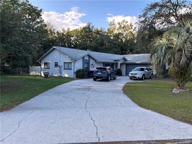 single story home featuring a garage and a front lawn