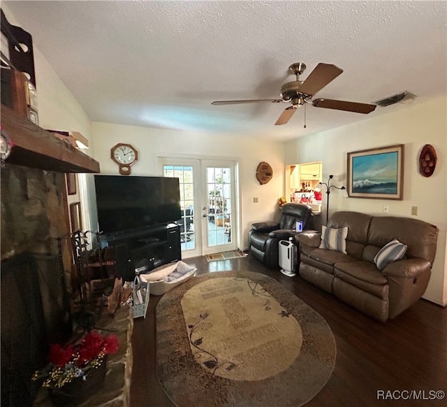 living room featuring french doors, a textured ceiling, hardwood / wood-style flooring, and ceiling fan