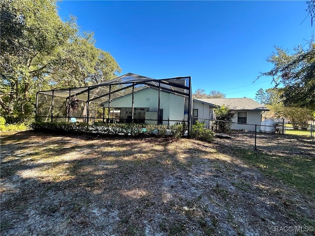 rear view of property featuring a lanai