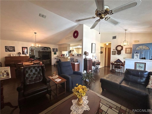 living room featuring hardwood / wood-style floors, ceiling fan with notable chandelier, a textured ceiling, and lofted ceiling