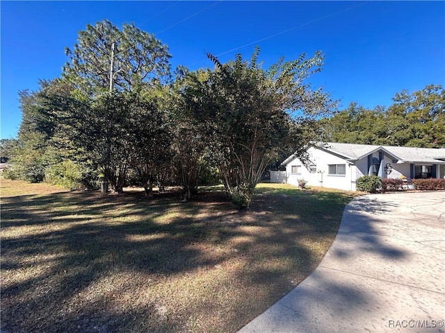 view of side of home with a lawn