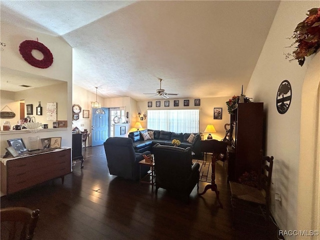 living room with lofted ceiling, a textured ceiling, ceiling fan, and dark wood-type flooring