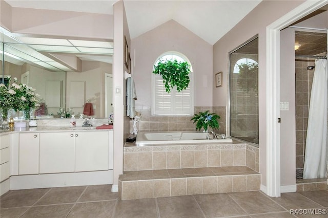 bathroom with lofted ceiling, a garden tub, a shower stall, and tile patterned flooring