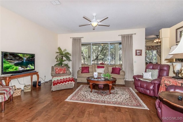 living room featuring ceiling fan, visible vents, and dark wood-style flooring