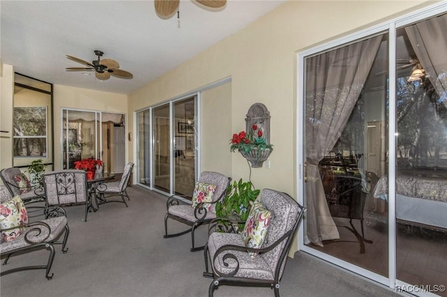 sunroom featuring a ceiling fan