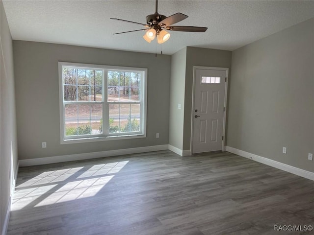 entrance foyer featuring ceiling fan, light hardwood / wood-style floors, and a textured ceiling