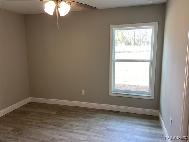 spare room featuring hardwood / wood-style floors and ceiling fan